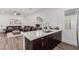 Bright and open kitchen area with island, seating, and modern finishes at 302 Watteau Ct, Henderson, NV 89012