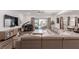 Bright living room features a large sectional sofa, piano, and access to outdoor space at 302 Watteau Ct, Henderson, NV 89012