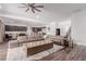 Open-concept living room with large sectional, flows into kitchen and dining areas at 302 Watteau Ct, Henderson, NV 89012