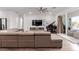 Bright living room features a large sectional sofa, media center, and sliding glass doors at 302 Watteau Ct, Henderson, NV 89012