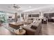 Open floor plan with modern living room, kitchen, and dining area with access to outdoor living at 302 Watteau Ct, Henderson, NV 89012