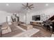 Open living space with hardwood floors, neutral paint, a large sectional, and a piano at 302 Watteau Ct, Henderson, NV 89012