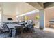Relaxing covered outdoor living space with large TV, dining set, BBQ and heaters; perfect for entertaining at 302 Watteau Ct, Henderson, NV 89012