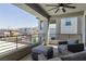 A covered patio with stylish furniture overlooks the neighborhood, providing an outdoor seating space for relaxing and entertaining guests at 302 Watteau Ct, Henderson, NV 89012