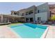 Backyard view of the sparkling pool with several lounge chairs and outdoor furniture available to enjoy the outdoor space at 302 Watteau Ct, Henderson, NV 89012