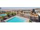 A modern outdoor pool with a view of desert hills offers an enjoyable retreat with privacy and space for entertainment at 302 Watteau Ct, Henderson, NV 89012