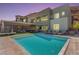 Beautiful backyard featuring a sparkling pool, modern home, and comfortable lounge chairs at 302 Watteau Ct, Henderson, NV 89012