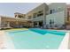 Backyard featuring a sparkling pool, comfortable lounge chairs and covered patio for relaxation at 302 Watteau Ct, Henderson, NV 89012