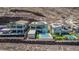 Modern home shows rear exterior view complete with a pool and yard space surrounded by desert landscaping at 302 Watteau Ct, Henderson, NV 89012