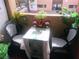 Inviting balcony view with a table and chairs surrounded by lush greenery at 3151 Soaring Gulls Dr # 2035, Las Vegas, NV 89128