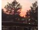 Exterior view of the community buildings at dusk featuring a colorful sky and mature trees at 3151 Soaring Gulls Dr # 2035, Las Vegas, NV 89128