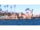 Stunning lakefront view with palm trees, beach access, and building with tower under clear sky at 3151 Soaring Gulls Dr # 2035, Las Vegas, NV 89128