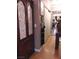 Hallway with wooden cabinet, dress on hanger, and a mirrored sliding door to another room at 3151 Soaring Gulls Dr # 2035, Las Vegas, NV 89128