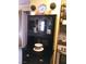 Charming kitchen featuring dark wood furniture, glass cabinets, and decorative plants at 3151 Soaring Gulls Dr # 2035, Las Vegas, NV 89128