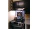 Kitchen stove with stainless steel range hood, patterned backsplash, and black cabinetry at 3151 Soaring Gulls Dr # 2035, Las Vegas, NV 89128