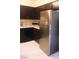 The kitchen features a stainless steel refrigerator with black cabinets and a black dishwasher at 3151 Soaring Gulls Dr # 2035, Las Vegas, NV 89128