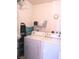Functional laundry area with modern appliances, shelving, and well-organized space at 3151 Soaring Gulls Dr # 2035, Las Vegas, NV 89128