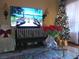 Cozy living room featuring decorative vases, Christmas tree, and wall mounted television at 3151 Soaring Gulls Dr # 2035, Las Vegas, NV 89128