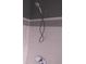 The shower features white tile with a light blue border and a shiny, modern showerhead at 3151 Soaring Gulls Dr # 2035, Las Vegas, NV 89128