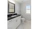 Bathroom features white vanity with black countertop and a large mirror at 3197 Castle Canyon Ave, Henderson, NV 89052
