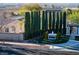 View of the Palermo residential community entrance with well maintained landscaping and manicured trees at 3197 Castle Canyon Ave, Henderson, NV 89052