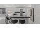 Open kitchen with a large island, seating, stainless steel appliances, and lots of cabinets at 3197 Castle Canyon Ave, Henderson, NV 89052