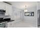 Bright kitchen with modern appliances, black countertops, and an adjacent dining area at 3197 Castle Canyon Ave, Henderson, NV 89052