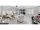 This staged living room features lots of natural light and modern decor at 3197 Castle Canyon Ave, Henderson, NV 89052