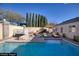 Enjoy the backyard with a sparkling pool, relaxing lounge chairs, and an umbrella for shade on a sunny day at 3197 Castle Canyon Ave, Henderson, NV 89052