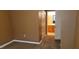 Bedroom shot showing a glimpse of the bathroom with neutral walls and carpet flooring at 3318 N Decatur Blvd # 1002, Las Vegas, NV 89130