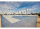Community basketball court featuring multiple hoops, benches, and lighting for neighborhood recreation and play at 3525 Serravalle Ln, Henderson, NV 89044