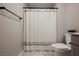 Cozy bathroom with blue-striped shower curtain, toilet, and vanity, creating a clean and functional space at 3525 Serravalle Ln, Henderson, NV 89044