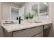 Modern bathroom features quartz countertop, gray cabinetry and dual vanity mirrors at 3525 Serravalle Ln, Henderson, NV 89044