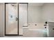 Stylish bathroom featuring a glass-enclosed shower, soaking tub, and contemporary fixtures, creating a luxurious retreat at 3525 Serravalle Ln, Henderson, NV 89044