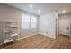 A modern bedroom with hardwood floors, a wall design, and natural light at 3525 Serravalle Ln, Henderson, NV 89044