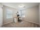 Bedroom with neutral carpet and paint, and a wood and white desk beneath a bright window at 3525 Serravalle Ln, Henderson, NV 89044