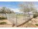 Fenced community dog park featuring trees, grass, and benches for residents to enjoy with their pets at 3525 Serravalle Ln, Henderson, NV 89044