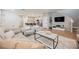 Bright and airy living room featuring a modern kitchen view, stylish decor, and hardwood floors at 3525 Serravalle Ln, Henderson, NV 89044
