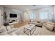 Cozy living room with hardwood floors, comfortable seating, and natural light at 3525 Serravalle Ln, Henderson, NV 89044