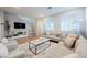 Cozy living room with hardwood floors, media console, comfortable seating, and natural light at 3525 Serravalle Ln, Henderson, NV 89044