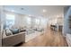 Spacious living room with modern decor, open kitchen, and hardwood floors at 3525 Serravalle Ln, Henderson, NV 89044