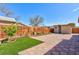 Spacious backyard featuring a brick patio, a shed, green grass, and a wooden fence at 3814 Connie Ave, Las Vegas, NV 89115