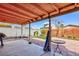 This backyard has a large patio, a wooden fence, and is surrounded by lush green trees at 3814 Connie Ave, Las Vegas, NV 89115