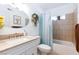 Bright bathroom featuring a vanity with ample counter space, decorative accents, and tiled shower and tub combo at 3814 Connie Ave, Las Vegas, NV 89115