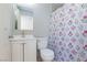 Freshly updated bathroom features floral shower curtain and a stylish vanity with sink and ample storage at 3814 Connie Ave, Las Vegas, NV 89115