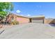Charming single-story home with a large driveway, and a gray garage door at 3814 Connie Ave, Las Vegas, NV 89115