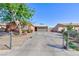 Charming single-story home with a large driveway, fenced yard, and mature trees at 3814 Connie Ave, Las Vegas, NV 89115