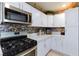 Updated kitchen with white cabinets, quartz countertops, stainless appliances, and tile floors at 3814 Connie Ave, Las Vegas, NV 89115