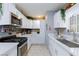 Updated kitchen with white cabinets and stainless steel appliances at 3814 Connie Ave, Las Vegas, NV 89115
