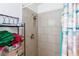 Clean shower featuring a tiled wall with a built in shelf, showerhead, and shower curtain at 3814 Connie Ave, Las Vegas, NV 89115